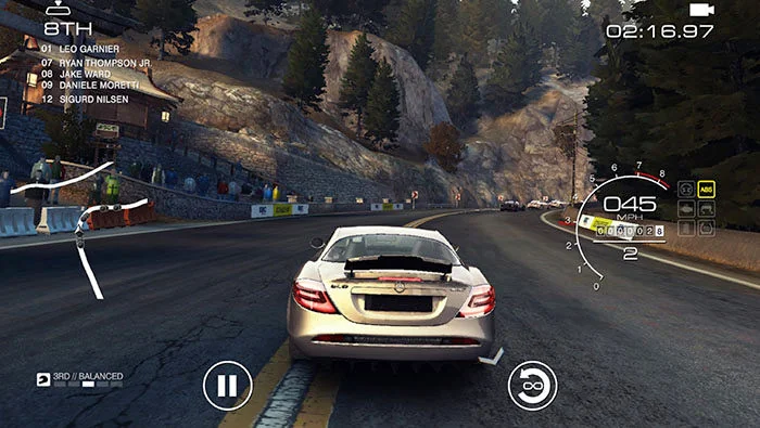 silver mercedes driving through a mountain pass in GRID autosports one of the best racing game sin 2025